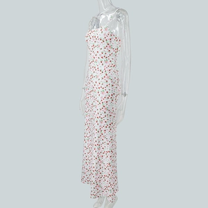 Side view of floral slip maxi dress with red and pink flower patterns on white fabric