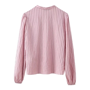 Detail view of pink vertical stripes and lightweight textile texture on the shirt back