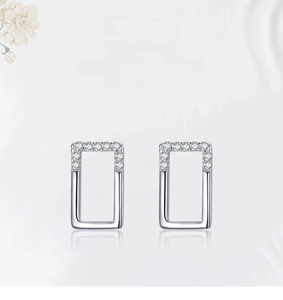 Close-up of geometric square S925 silver earrings with sparkling zircon micro-pave setting