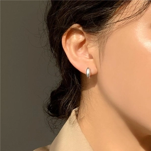 Minimalist 925 sterling silver hoop earrings with polished finish shown on model