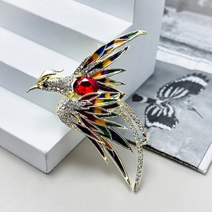 Elegant phoenix brooch with red crystal and colorful enamel inlay in gold plating