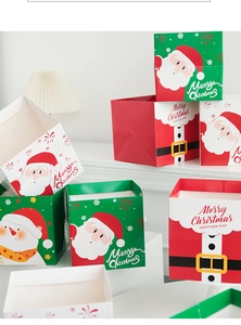 Close-up of Santa Claus and snowman paper gift boxes with Merry Christmas greeting