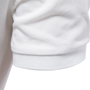 Close-up detail of white piqué cotton polo shirt sleeve showing ribbed cuff texture