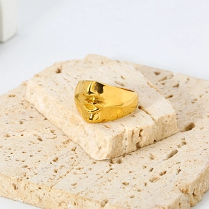 Detailed close-up of 18K gold plated stainless steel ring with abstract face sculpture