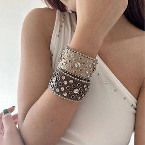 Set of two wide faux leather bracelets featuring metallic studs and rhinestone inlay