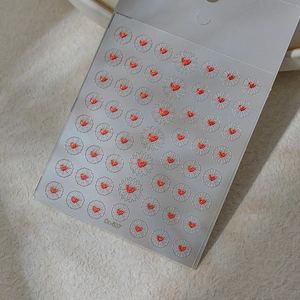 Detailed view of red heart nail stickers with silver sunburst base pattern Co-537
