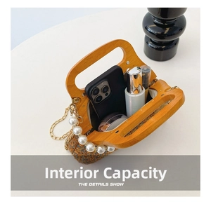 Internal view of woven pearl handbag showing space for phone and makeup essentials
