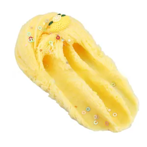 Detail of yellow cloud slime featuring colorful sequins and a realistic lemon slice accessory