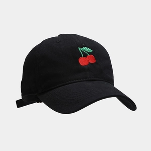 Detail of red cherry embroidery on black cotton twill baseball cap with soft top design