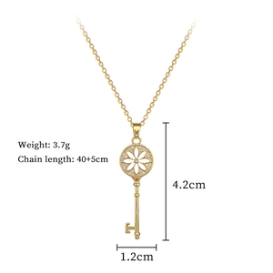 Detailed view of gold sunflower key necklace with crystal pavé and size measurements