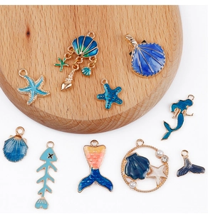 Macro detail of blue ocean theme charms like starfish and shells for DIY jewelry making