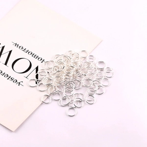 Assorted silver open jump rings for handmade jewelry making on a white background