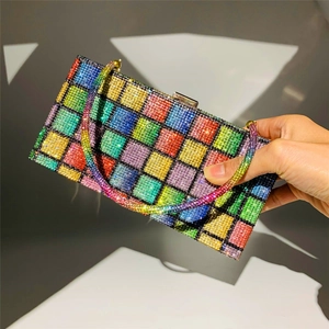 Close-up of rainbow rhinestone clutch bag featuring colorful crystals and metal frame