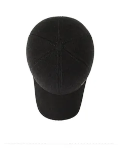 Top view of thick winter baseball cap featuring textured wool fabric and a metal logo