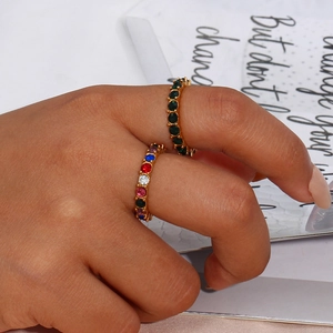 Eternity gold rings with green and rainbow stones on finger, 18k gold plated stainless steel
