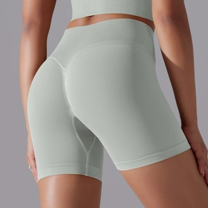 Detailed close-up of high-waist seamless ribbed yoga shorts with butt-lifting curved seams