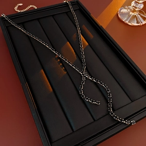 Detail of a black Y-shaped zirconia water drop tassel necklace on jewelry display