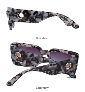 Detail of tortoise shell sunglasses featuring a round hollow gold metal hinge design