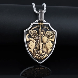 Detail of shield-shaped Archangel Michael pendant in silver and gold-tone stainless steel