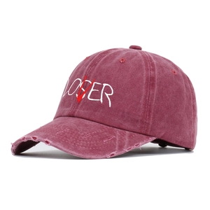 Close-up of vintage washed burgundy cotton cap with white LOSER LOVER embroidery