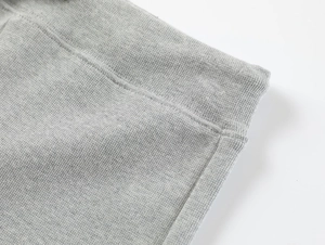 Close-up of grey high-waist yoga shorts showing seamless stitching and knit fabric texture
