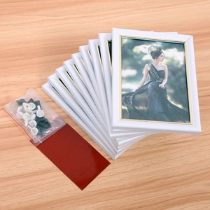 Modern white 7-inch photo frame set with golden inner edges and mounting accessories