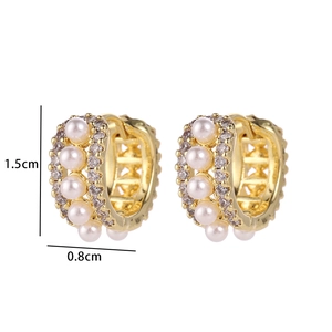 Detail shot of gold hoop earrings with pearls and zircons measuring 1.5cm by 0.8cm