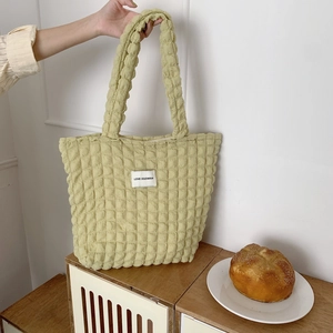 Detail of light green bubble texture tote bag with LOVE SOZAKKA woven label patch