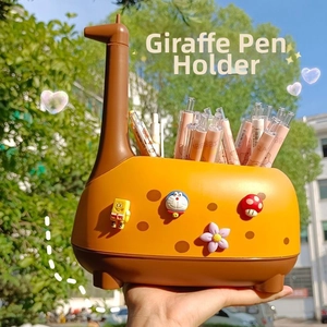Close-up of a yellow giraffe-shaped pen holder featuring cute cartoon 3D character charms
