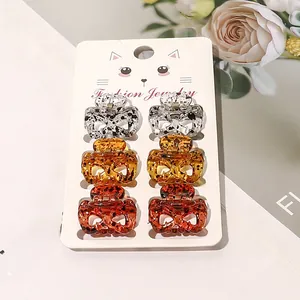 Set of 6 mini hair claws with cat-ear shapes and leopard patterns on display card