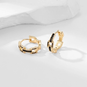 Detail of gold-plated hoop earrings featuring chain links and black zircon stones