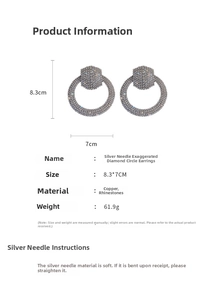 Close-up detail of oversized silver needle hoop earrings with full rhinestone inlay