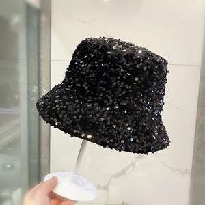 Close-up detail of a chic black bucket hat featuring a full-coverage shiny sequin texture