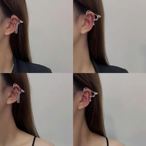 Detailed view of silver elf ear cuffs with sparkling tassels and teardrop pendants