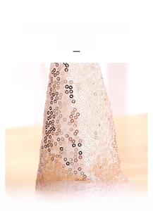 Close-up detail of champagne gold sequins fabric on the gnome doll decorative ornament