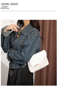 Model wearing white woven leather bag with gold chain strap against minimalist wall