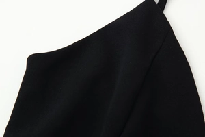 Detail of shoulder strap and V-neckline stitching on the black polka dot slim dress