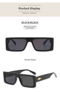 Macro detail of rectangle sunglasses with golden insect decor on black wide frames