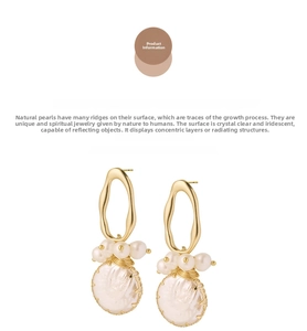 Detail of gold oval hoops with baroque pearls featuring natural growth texture