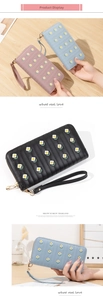 Detail of floral embroidery on PU leather long wallet with wrist strap for women