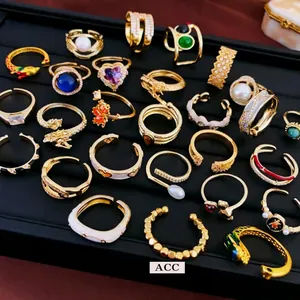 Golden alloy rings set with pearls, colorful gemstones and heart-shaped designs