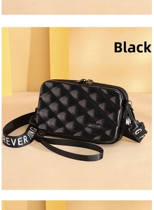 Close-up of black PC hardshell mini suitcase crossbody bag with diamond texture