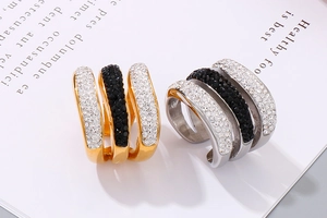 Detail of triple-row pave zircon ring in gold and silver finish on a book