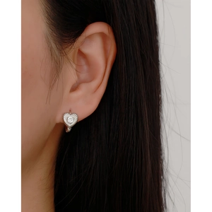 Close-up of heart-shaped s925 silver hoop earring with radial texture and zircon