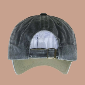 Detail of adjustable metal buckle and vintage washed cotton texture on baseball cap