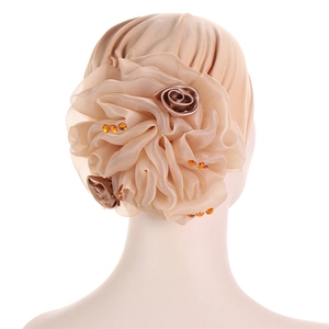 Detail of champagne satin turban featuring large organza flowers and orange crystal beads