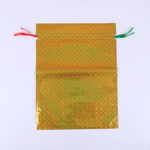 Golden holographic laser gift bag with red and green drawstrings for Christmas gifts