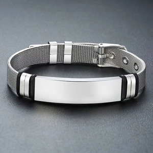 Detailed macro view of silver stainless steel mesh bracelet with polished engravable plate