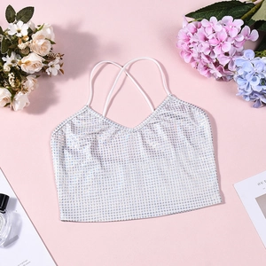 Flat lay of silver sequin crop top with thin straps and floral party aesthetic