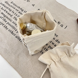 Detail view of cream canvas drawstring bag made of natural linen for jewelry storage